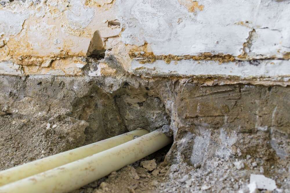 pipes beneath damaged foundation