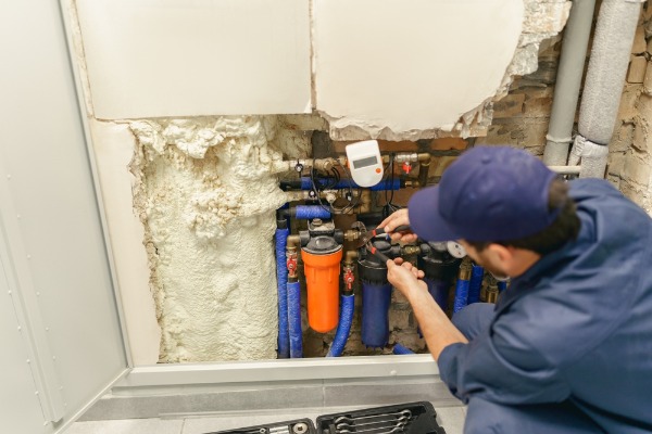 plumber servicing commercial water filtration system