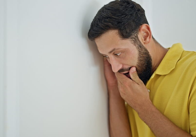 person with an ear to the wall