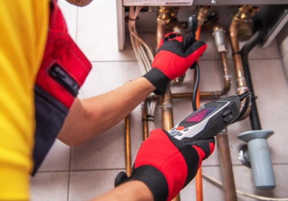plumber inspecting copper pipes