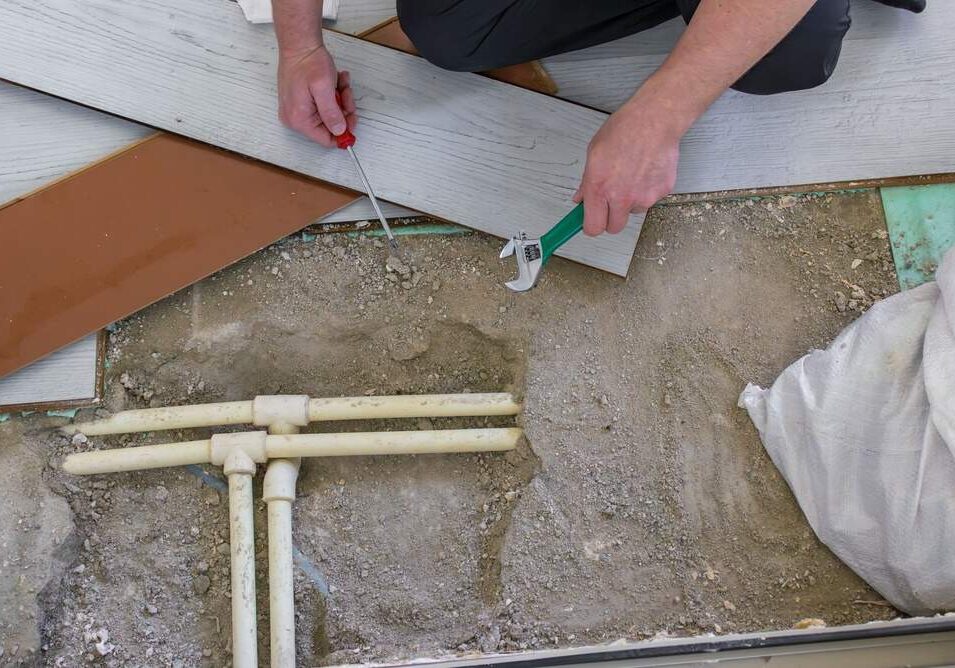 repairing pipes beneath flooring